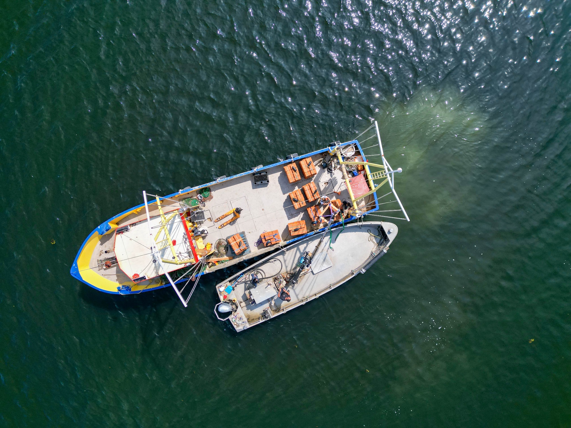 Aerial view of oyster brick deployment from boats at sea