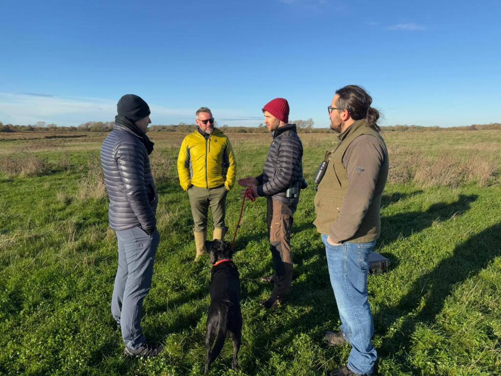 Four men and a dog discuss Rebalancing Nature