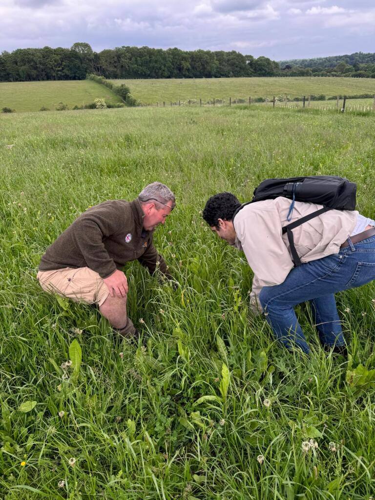 Farmer and Rebalance Earth staff inspecting soil quality